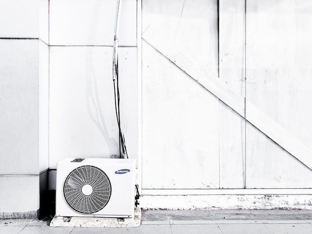 floor air conditioner next to white wall outside